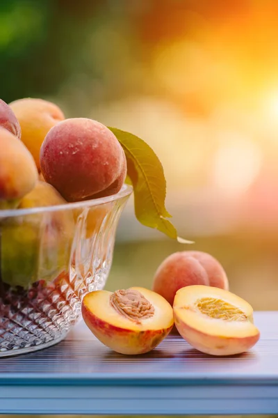 The basket of ripe, juicy peaches placed on the table