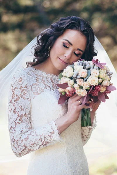 Beautiful bride outdoors in a forest. — Stock Photo, Image