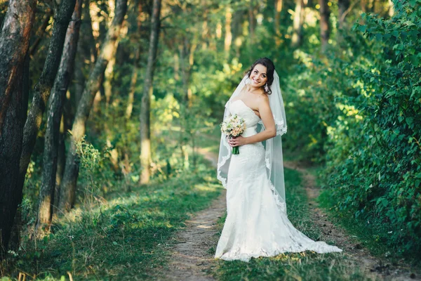 Beautiful bride outdoors in a forest — Stock Photo, Image