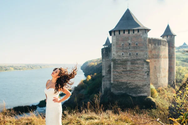 Wedding day. Gorgeous bride walking next to castle in west Ukrai — Stock Photo, Image