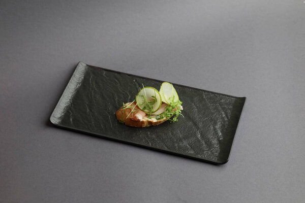 Appetizer crostini, open faced sandwiches with pear, prosciutto, microgreen and cheese. Delicious snack, appetizers.