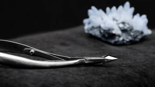 Beautiful nail clippers on a black background, nail clippers