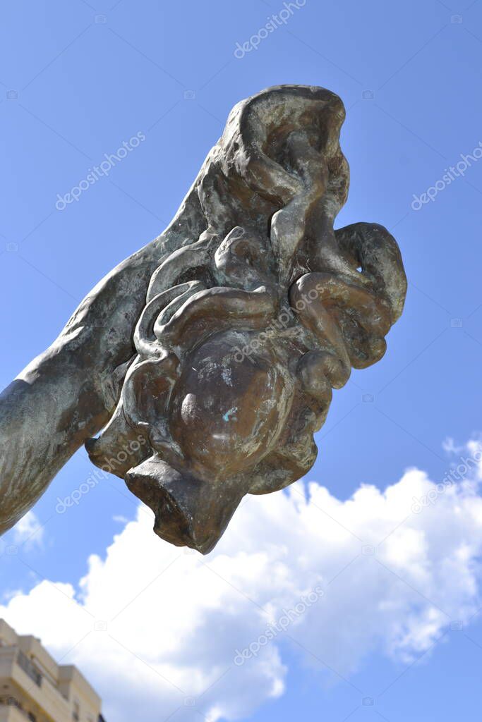 The head of Medusa, held by Perseus. Bronze statue by Salvador Dali on the Avenida del Mar in Marbella, Andaluca Spain. One of ten Dali sculptures on the plaza heading toward the marina.