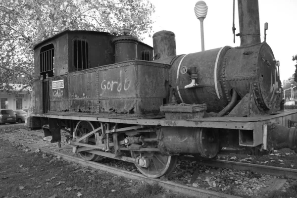 Black and White - Old Steam Engine Train at Crdoba Park. Andaluca, Spain. Rusty steam engine left as monument or decoration in Crdoba Park. Gloomy day, abandoned train. Mechanics, engine, cabin.