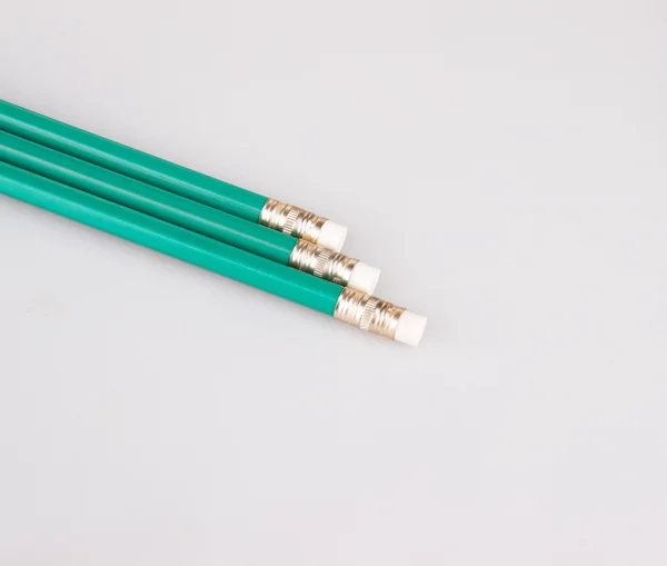 three pencils with erasers on white background