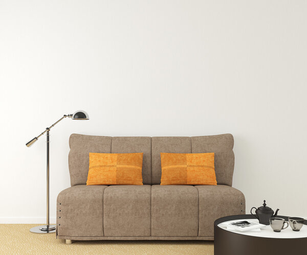 brown couch near empty white wall