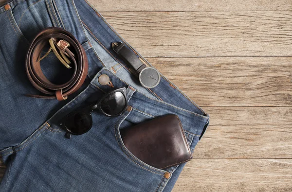 Jeans Wallet and Belt watches glasses  on wood background,top vi
