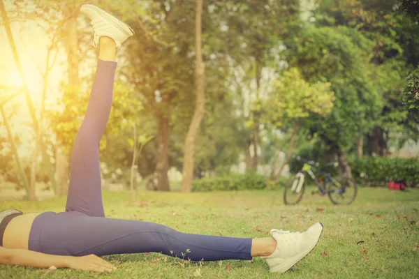 Jovem, exercício em gardent e fundo de bicicleta — Fotografia de Stock