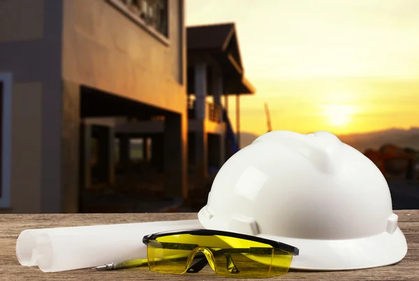 File of safety helmet and architect plant on wood table