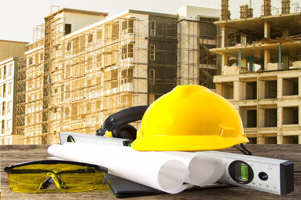 file of safety helmet and architect plant on wood table with  co