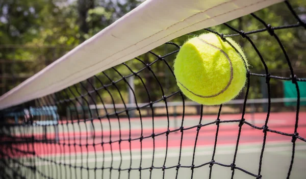 Tennis ball in net — Stock Photo, Image