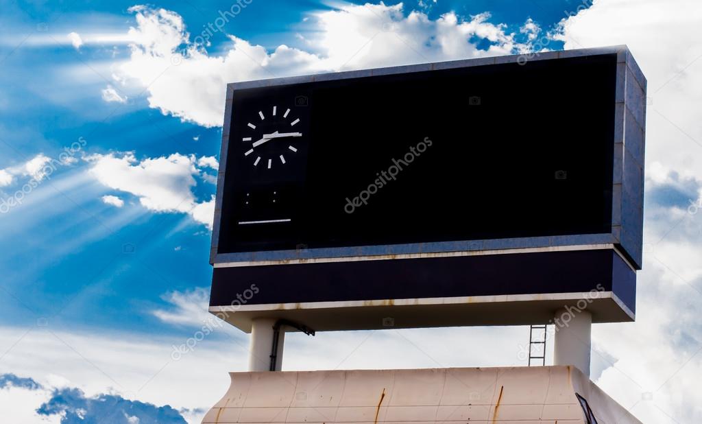 scoreboard at football stadium with sky with Clouds and Sun Rays