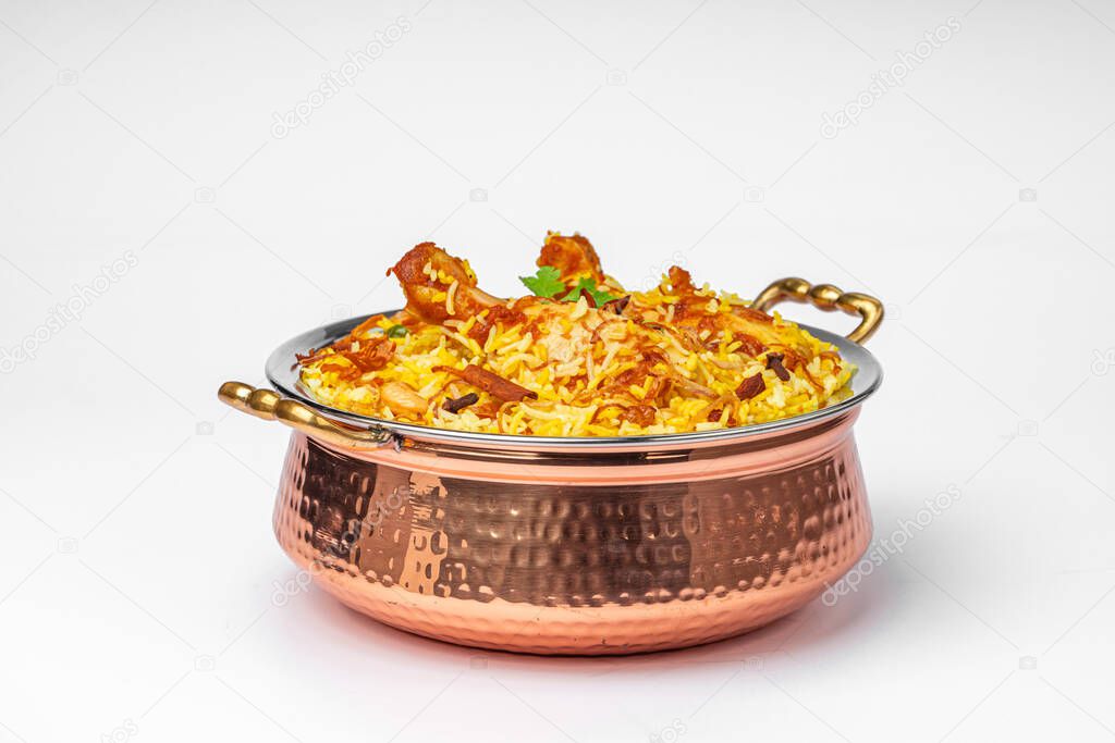 Chicken biryani , kerala style chicken dhum biriyani made using jeera rice and spices arranged in a brass serving bowl  with white background, isolated