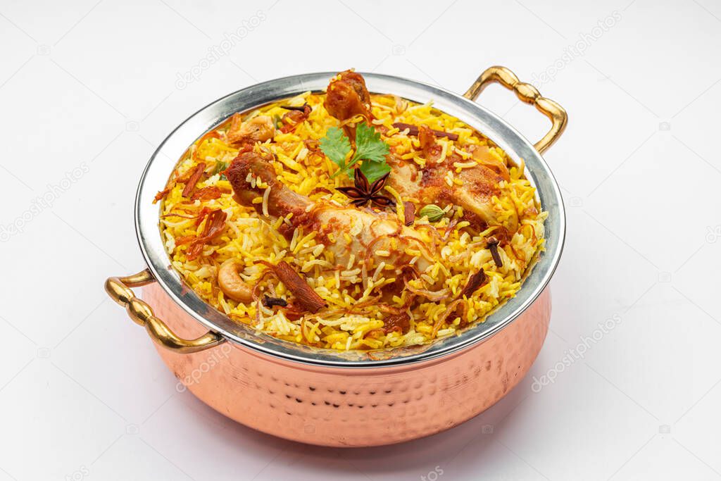 Chicken biryani , kerala style chicken dhum biriyani made using jeera rice and spices arranged in a brass serving bowl  with white background, isolated