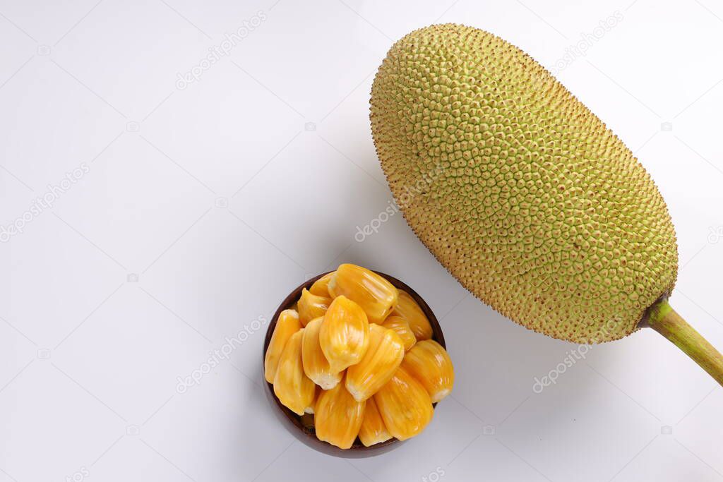 Ripe Jackfruit arranged beautifully in a wooden bowl  with white textured background.