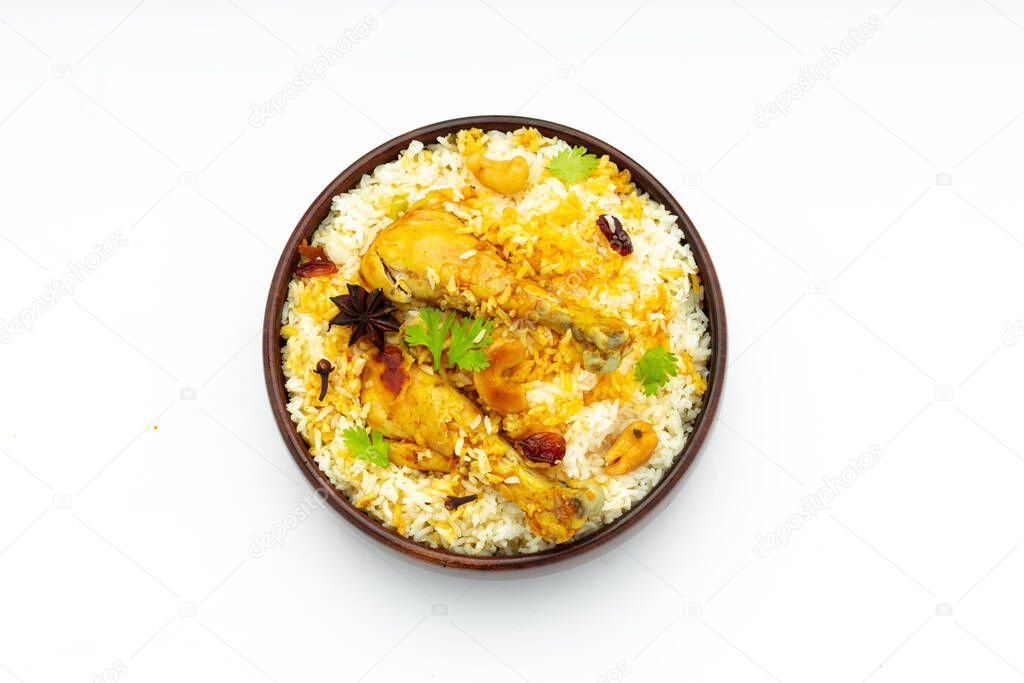 Chicken biryani , kerala style chicken dhum biriyani made using jeera rice and spices arranged in a wooden  tableware with white background, isolated and topview
