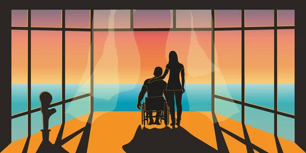 Bir kadın engelli bir adamı kucaklar ve denize bakar.