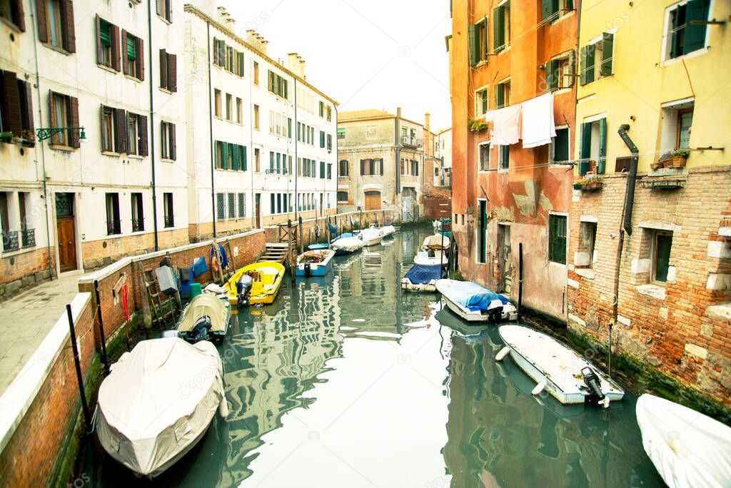 boats and motorboats parked on the canals of Venice