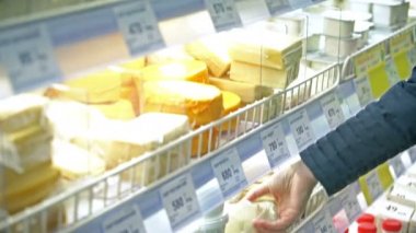 Moscow, Rusya Federasyonu - 21 Şubat 2016: Genç kadın peynir süpermarkette seçer.