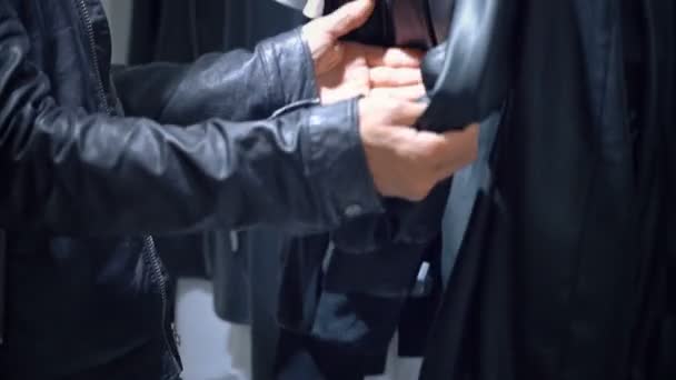 Man Hands Choosing The Black Leather Jacket — Stock Video