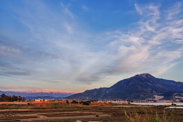 Lake overgrown with reeds mountains in background — Stock Photo, Image