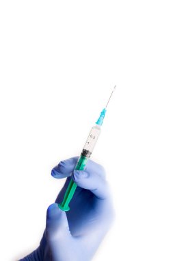 A doctors hand in a blue glove holding a syringe while taking liquid covid 19 corona virus vaccine. White background.