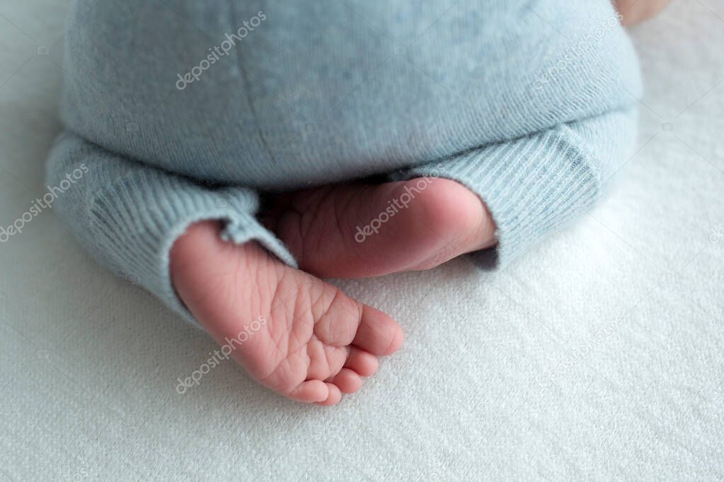 Baby feet. The tiny foot of a newborn in soft selective focus. Image of the soles of the feet.