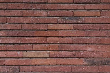 Eski, çiğ tuğlalardan yapılmış bir duvar dokusu. Duvarlar koyu kırmızı.. 