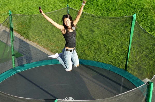 Girl having fun on a trampoline — Stock Photo, Image