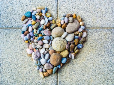 Heart made of colorful pebbles, love and diversity