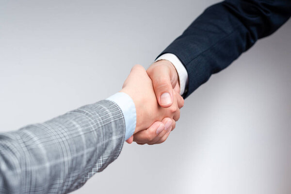 Corporate Businessmen Handshake Indoors.Two People Professionally Well Dressed Gesturing Togetherness.Working Colleague Partners Sign Deal In Agreement To Contract