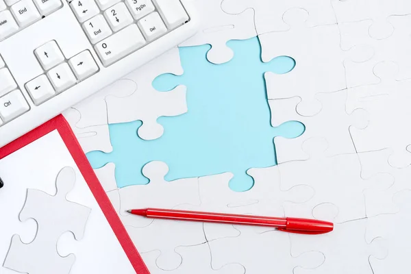 Close-Up White Jigsaw Pattern Puzzle Piezas que se conectarán con faltante última pieza colocada en un fondo plano con diferentes accesorios de textura y papel — Foto de Stock