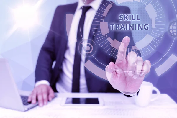 Text sign showing Skill Training. Word for designed to gain and enhance the knowledge an employee needs Bussiness Man Sitting Desk Laptop And Phone Pointing Futuristic Technology.