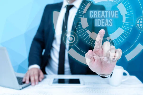 Hand writing sign Creative Ideas. Business overview Unique strategy for captivating audiences interest Bussiness Man Sitting Desk Laptop And Phone Pointing Futuristic Technology. — Stockfoto