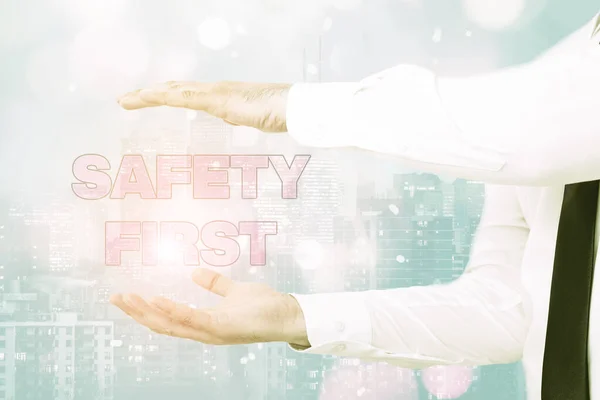 Hand writing sign Safety First. Business concept Avoid any unnecessary risk Live Safely Be Careful Pay attention Inspirational business technology concept with copy space — Stock Photo, Image