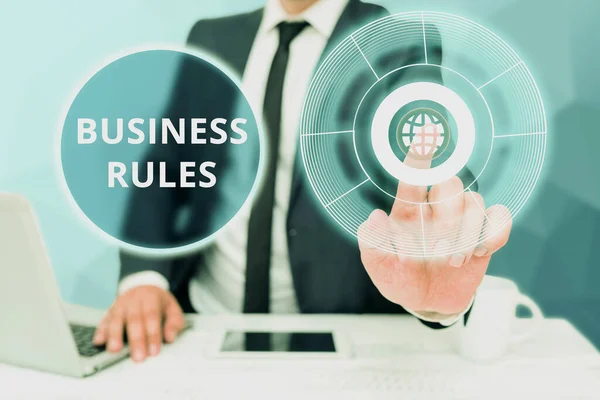 Sign displaying Business Rules. Word Written on the principles which determine the corporation s is activities Bussiness Man Sitting Desk Laptop And Phone Pointing Futuristic Technology.