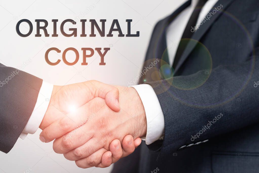 Inspiration showing sign Original Copy. Word Written on Main Script Unprinted Branded Patented Master List Two Professional Well-Dressed Corporate Businessmen Handshake Indoors