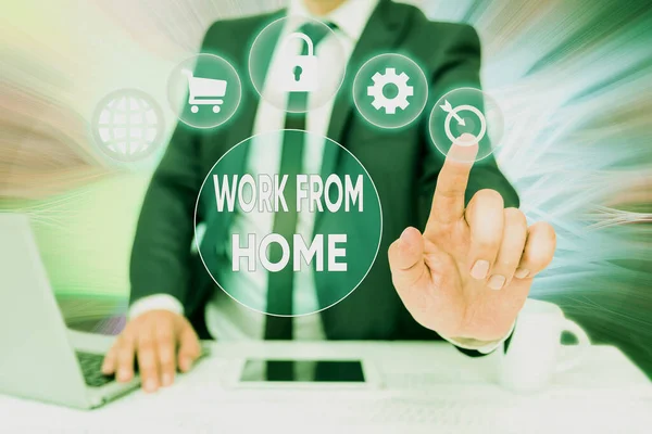 Inspiration showing sign Work From Home. Word Written on communicating with the company mainly from home flexibly Bussiness Man Sitting Desk Laptop And Phone Pointing Futuristic Technology. — 图库照片