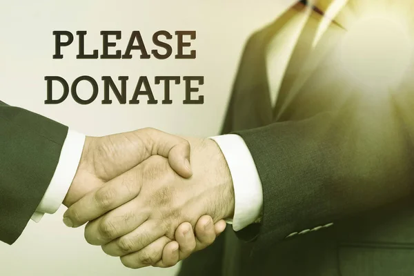 Handwriting text Please Donate. Business idea Supply Furnish Hand out Contribute Grant Aid to Charity Two Professional Well-Dressed Corporate Businessmen Handshake Indoors