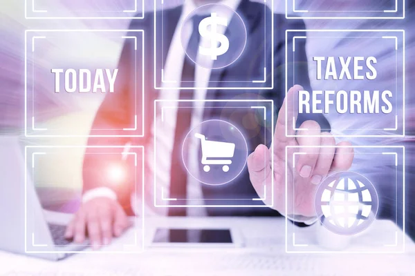 Inspiration showing sign Taxes Reforms. Word for managing collected taxes in a more efficient process Bussiness Man Sitting Desk Laptop And Phone Pointing Futuristic Technology.