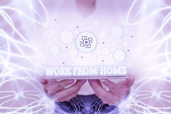 Writing displaying text Work From Home. Business approach communicating with the company mainly from home flexibly Lady In Uniform Standing Holding Tablet Showing Futuristic Technologies. — 图库照片