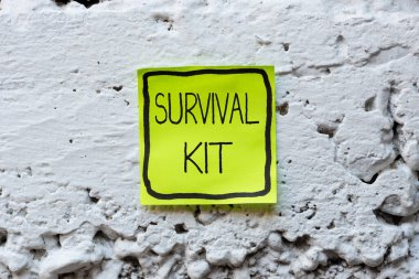 Survival Kit 'i gösteren bir tabela. Yeni Parlak Fikirlerin Yaratıcılık ve İlham Yenilemesini Düşünen birine Yardım Etmek için Acil Durum Malzemeleri Toplama
