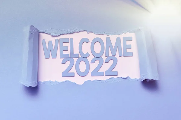 Text showing inspiration Welcome 2022. Internet Concept New Year Celebration Motivation to Start Cheers Congratulations Tear on sheet reveals background behind the front side — Stock Photo, Image