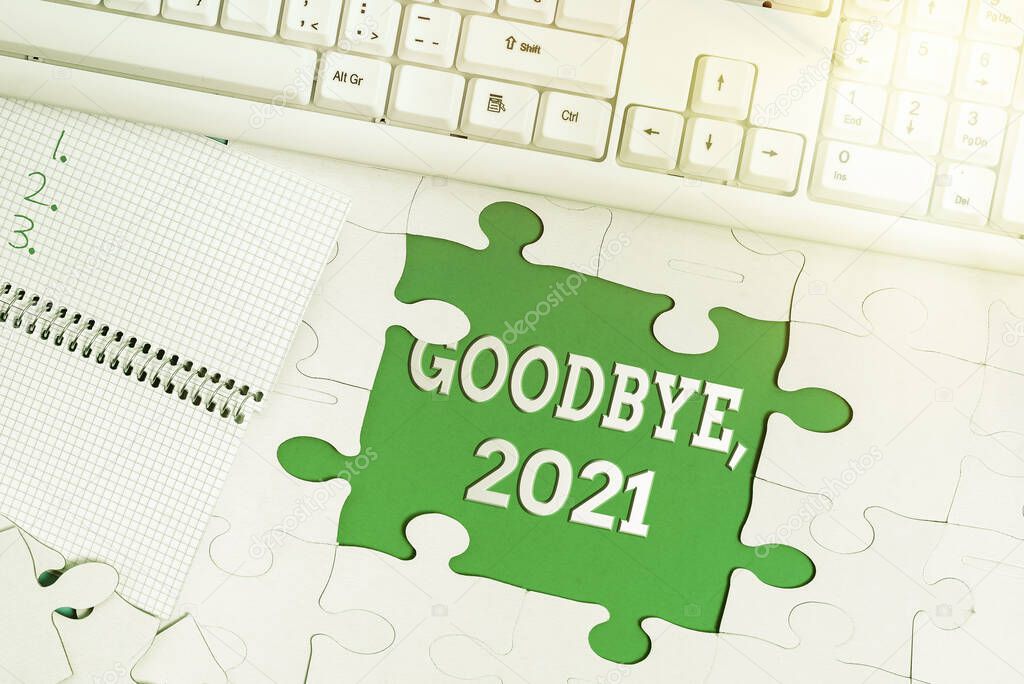 Hand writing sign Goodbye 2021. Conceptual photo New Year Eve Milestone Last Month Celebration Transition Building An Unfinished White Jigsaw Pattern Puzzle With Missing Last Piece