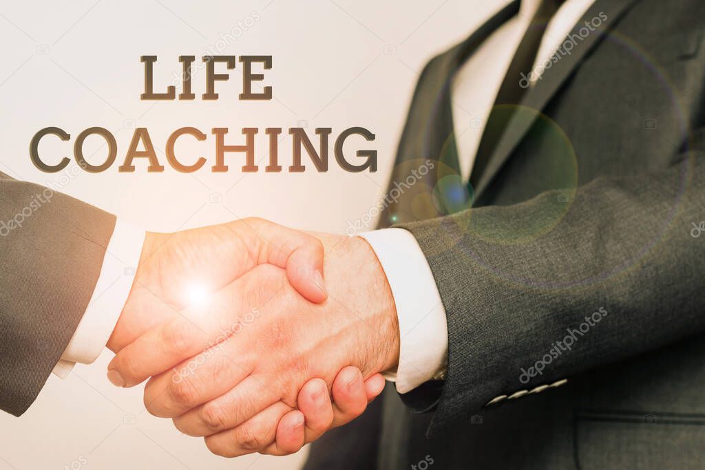 Text showing inspiration Life Coaching. Word for Improve Lives by Challenges Encourages us in our Careers Two Professional Well-Dressed Corporate Businessmen Handshake Indoors