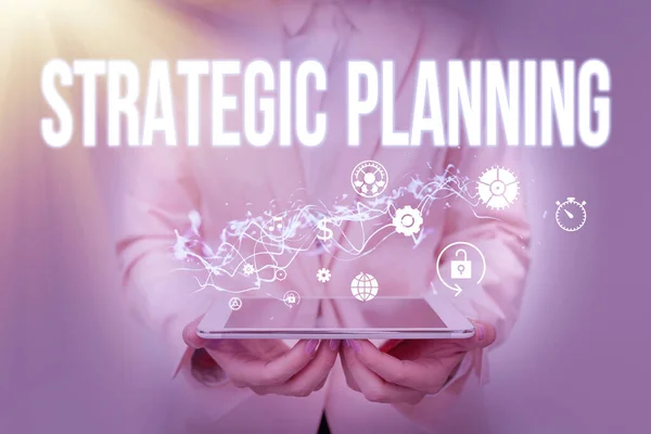 Text showing inspiration Strategic Planning. Business idea systematic process of envisioning a desired future Lady In Suit Holding Phone And Performing Futuristic Image Presentation. — Fotografia de Stock