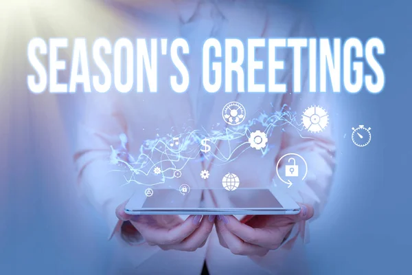 Writing displaying text Season S Is Greetings. Business idea Used as an expression of goodwill during festivities Lady In Suit Holding Phone And Performing Futuristic Image Presentation. — Fotografia de Stock