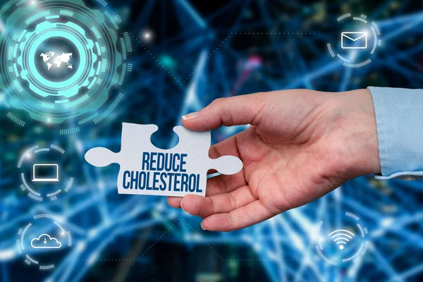 Text showing inspiration Reduce Cholesterol. Conceptual photo lessen the intake of saturated fats in the diet Hand Holding Jigsaw Puzzle Piece Unlocking New Futuristic Technologies.