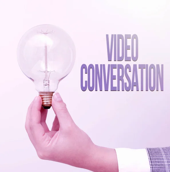 Sign displaying Video Conversation. Business approach Communicating visually with another person via computer Hand holding lamp showing or presenting new technology ideas