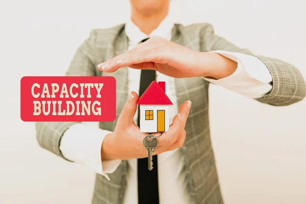 Sign displaying Capacity Building. Business showcase Strengthen the abilities of individuals Workforce planning Allocating Savings To Buy New Property, Saving Money To Build House —  Fotos de Stock